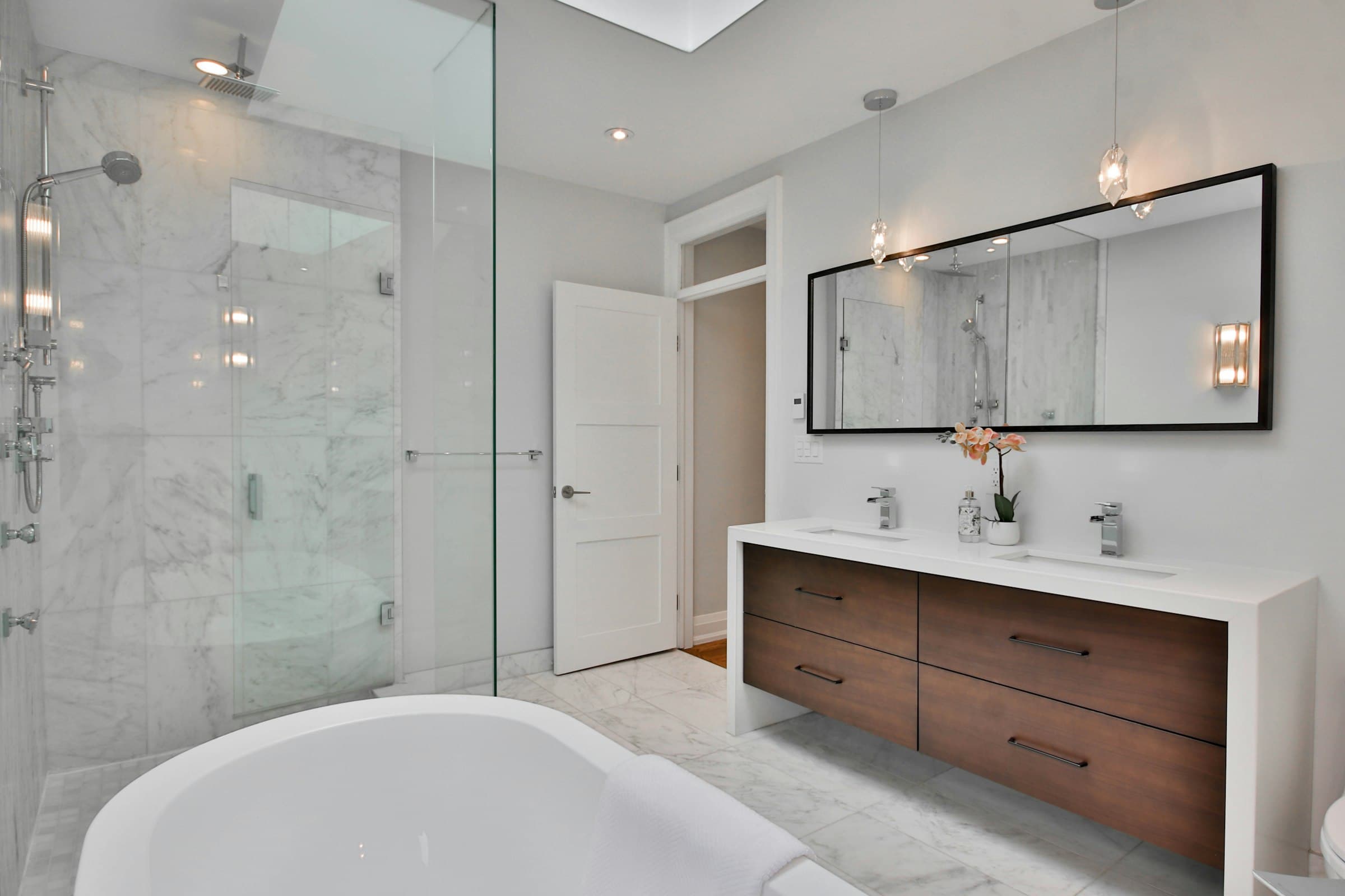 Marble bathroom with a glass walk-in shower and double vanity