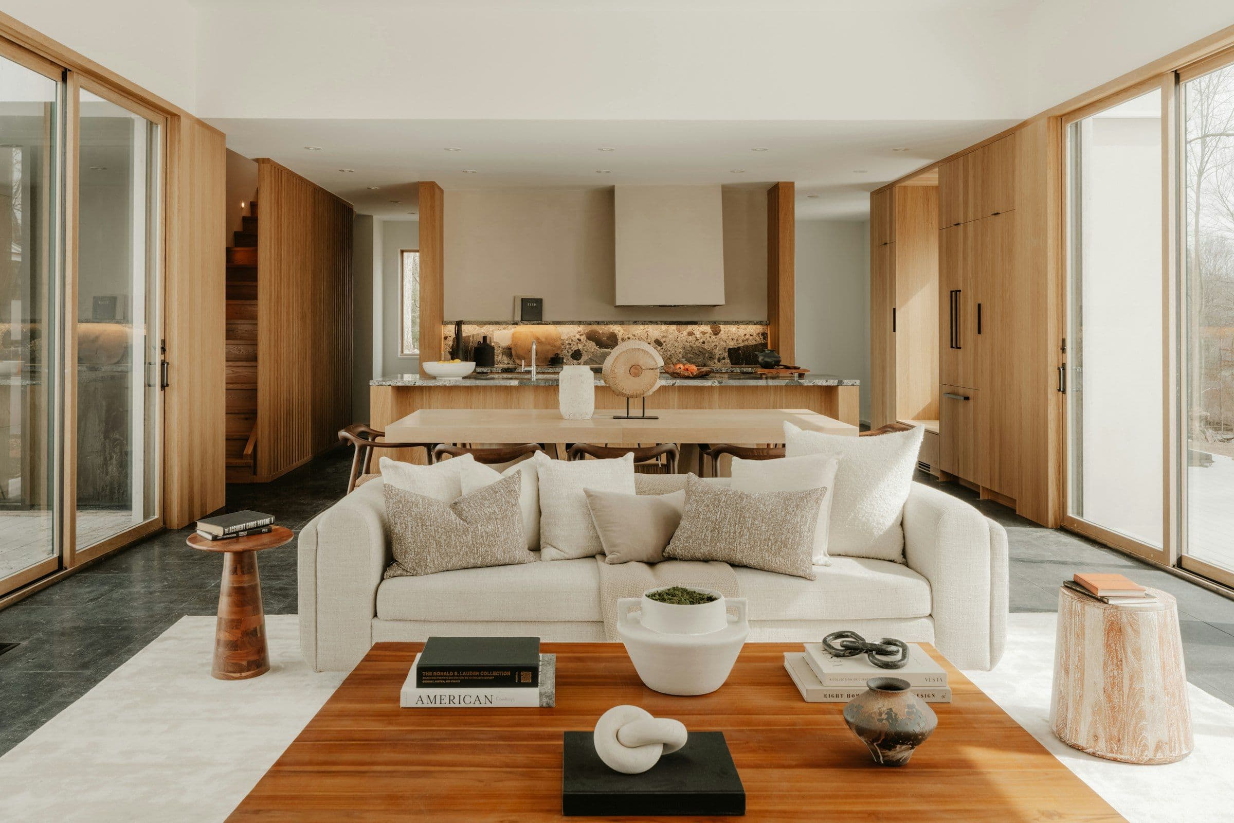 Contemporary great room with light-oak cabinetry and a sculptural kitchen