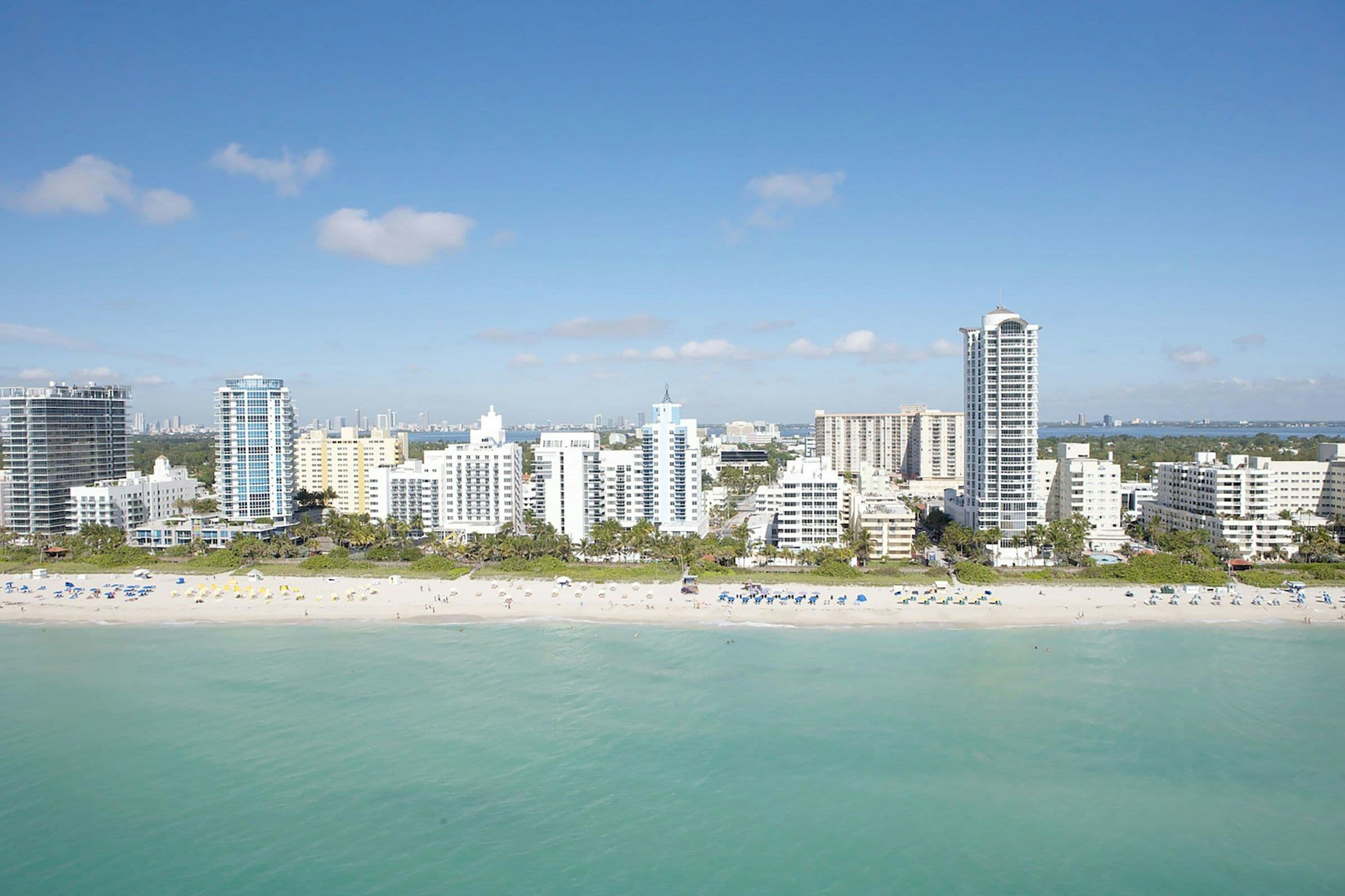Oceanfront condominium towers seen across turquoise water