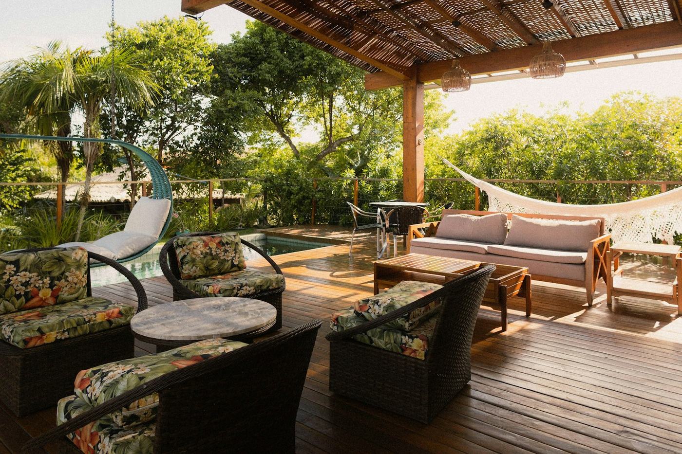 Covered wood deck and pergola beside a pool