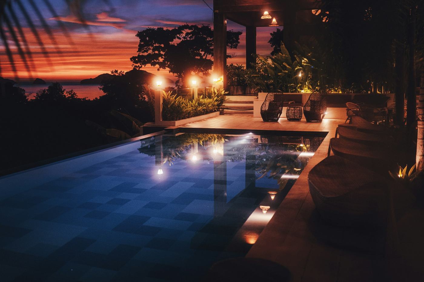 Lit infinity-edge pool at twilight